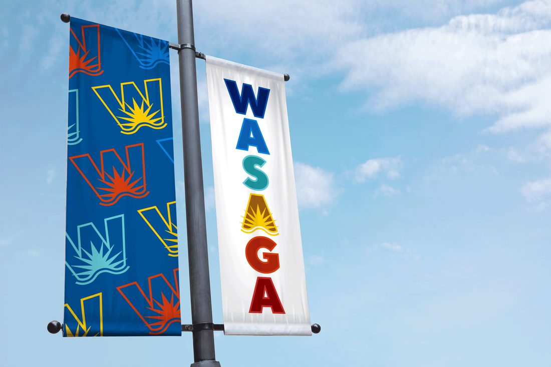 Wasaga Beach pole banners on a lamppost against a blue sky
