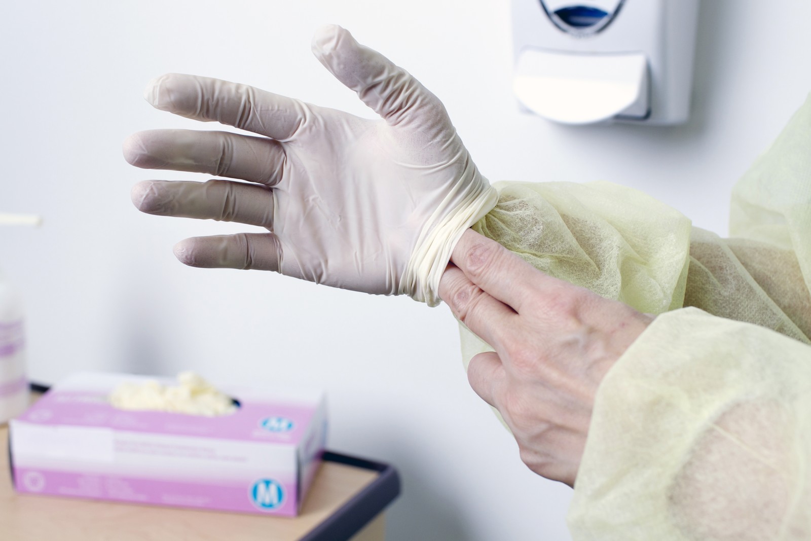 Doffing gloves: removing a glove at the end of care