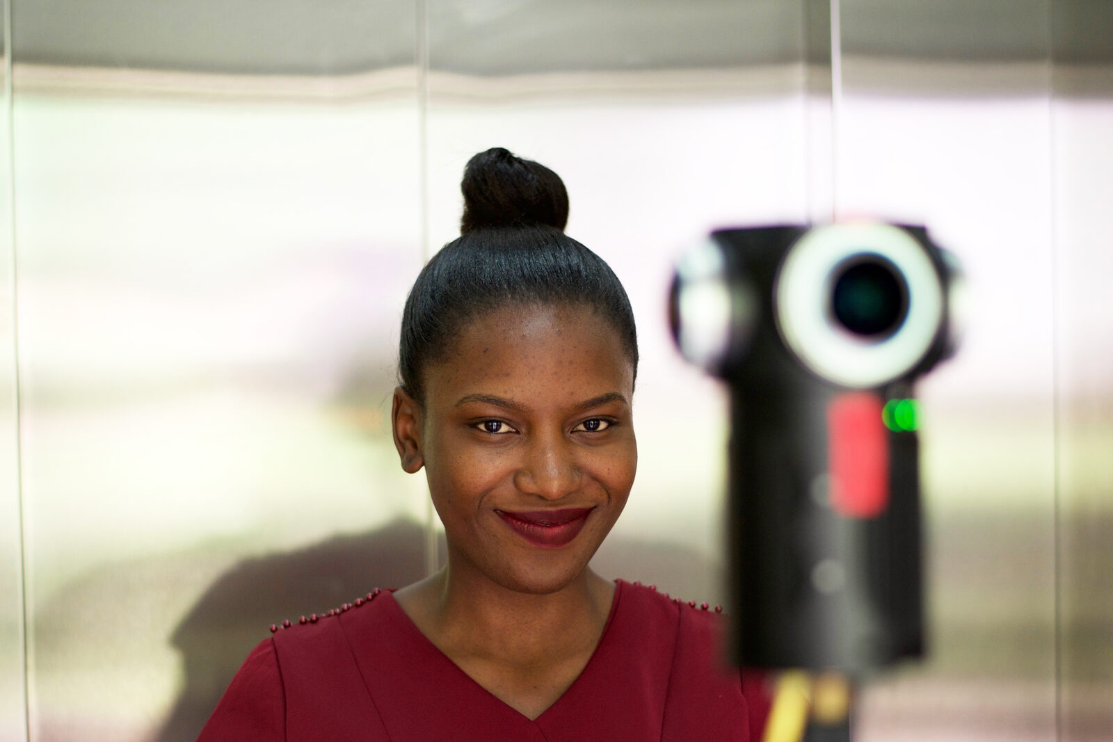 A young woman beside the 360° camera used to film Two Drops of Patience