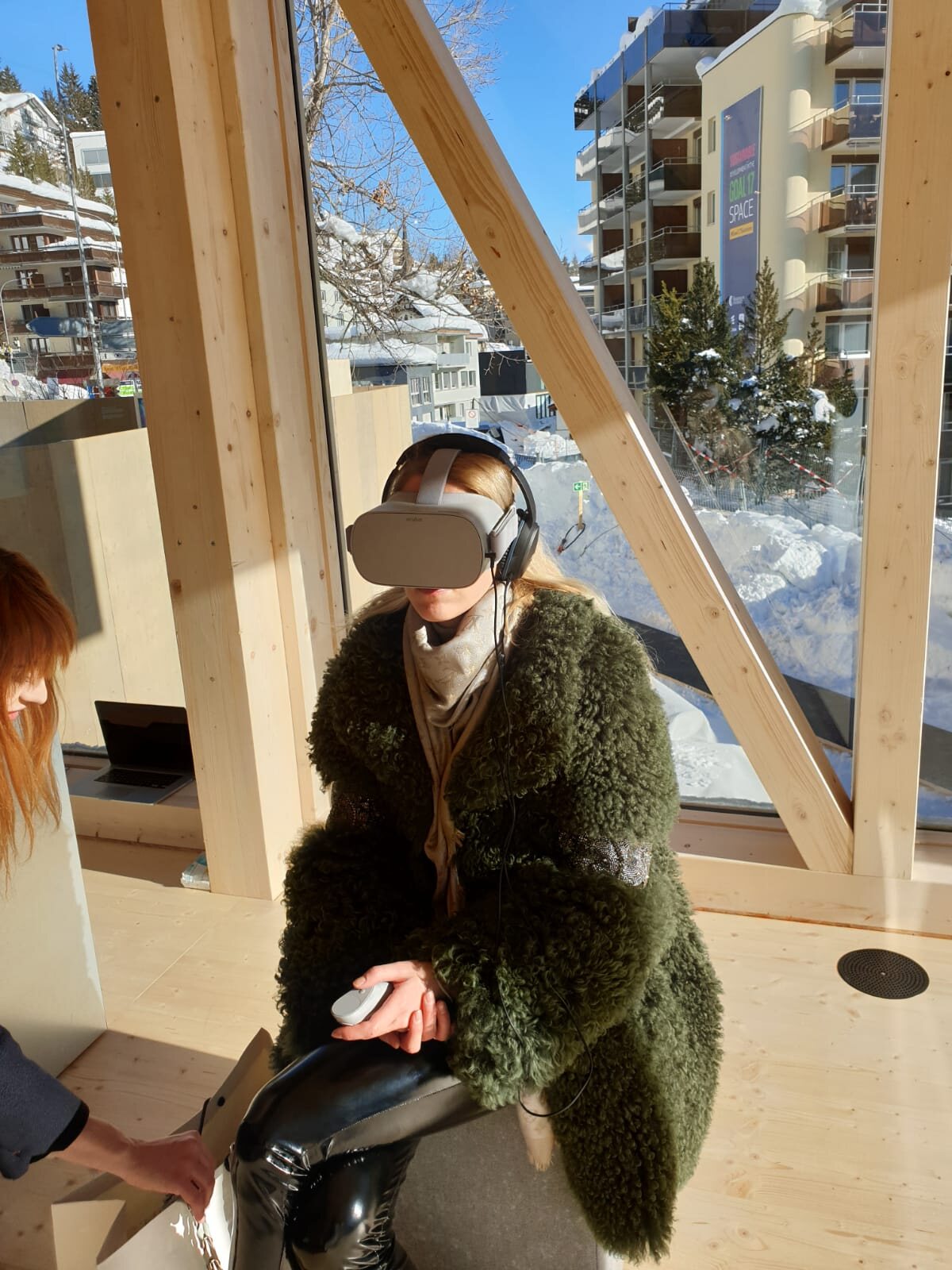 A guest handed the controller for a UNICEF360 Oculus experience in Davos, 2022