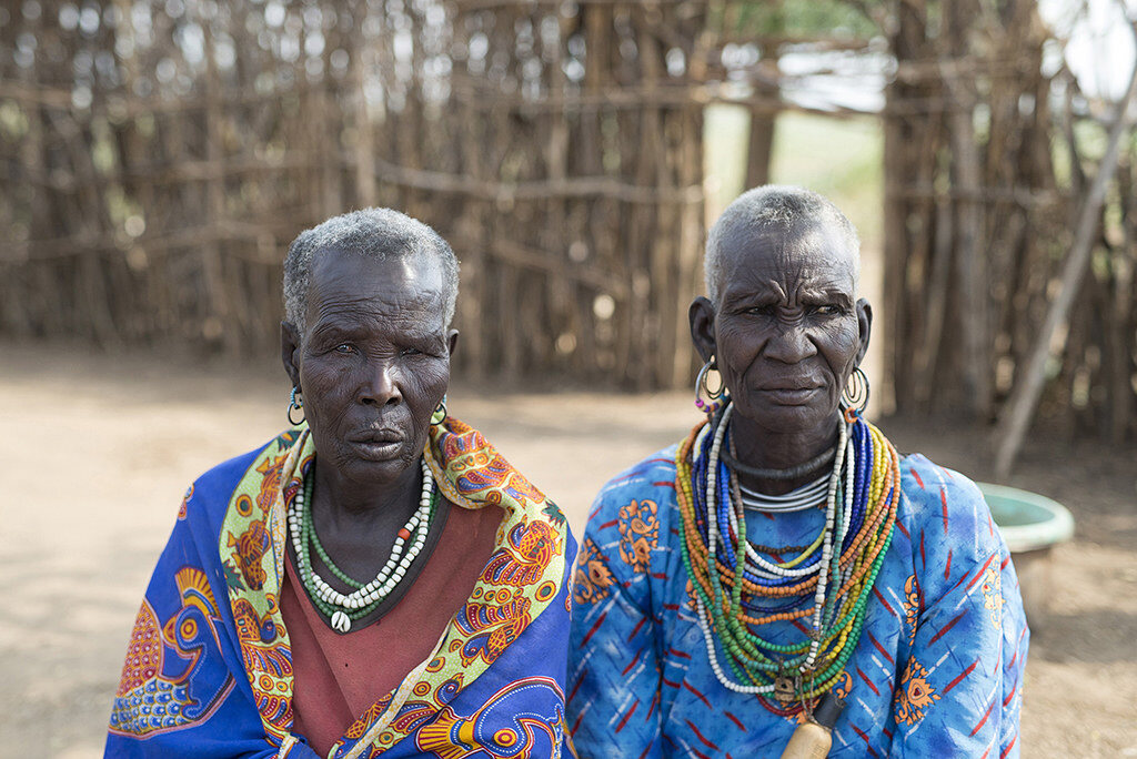 Two Karamojong elders in traditional beadwork and cloth