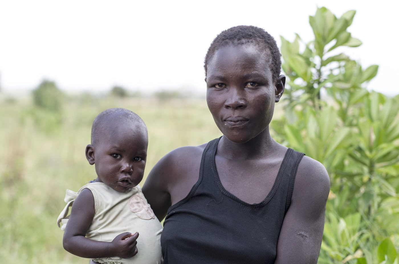 Lucy holding her young daughter Aliat in the Karamoja region of Uganda
